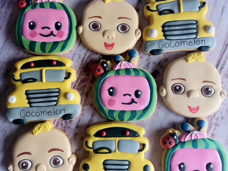 Cocomelon themed gender reveal iced cookies with watermelon shapes and colorful designs