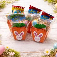 Adorable carrot-shaped gift box with bunny face containing chocolate marshmallow egg and iced bunny cookie