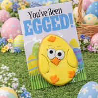 Adorable You've Been Egged chick iced cookie on colorful Easter card with decorated eggs and spring flowers